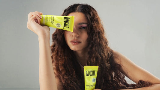 A woman with Indian curly hair showcases a stylish layered haircut, enhancing her natural curls and texture.